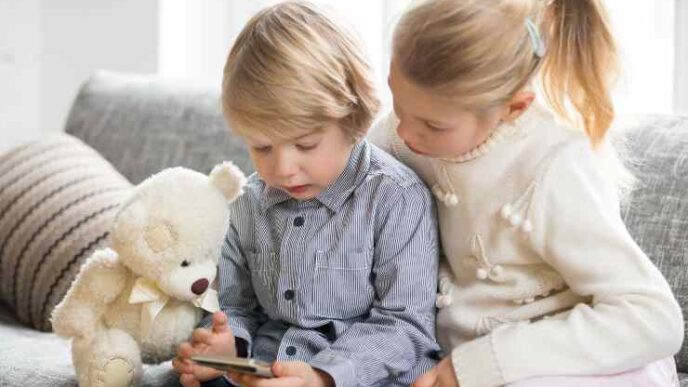 Kids Boy Girl Using Smartphone Together Sitting Sofa 1