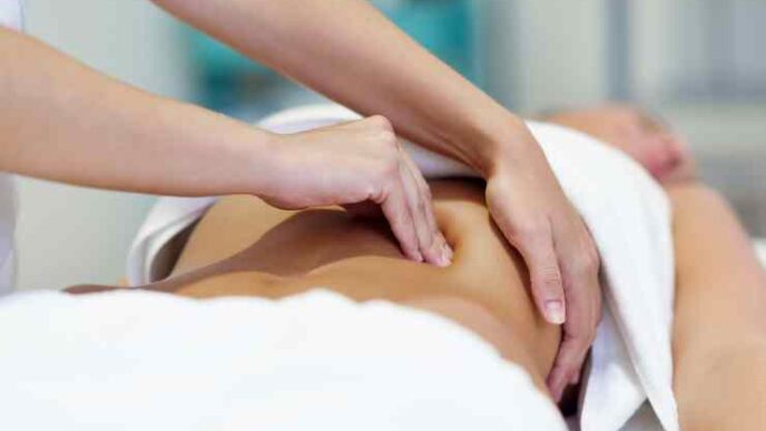 Woman Having Abdomen Massage By Professional Osteopathy Therapist 1