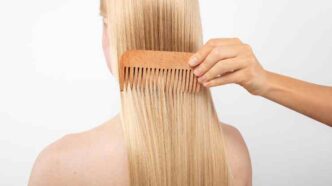 Close Up Hand Using Comb 1